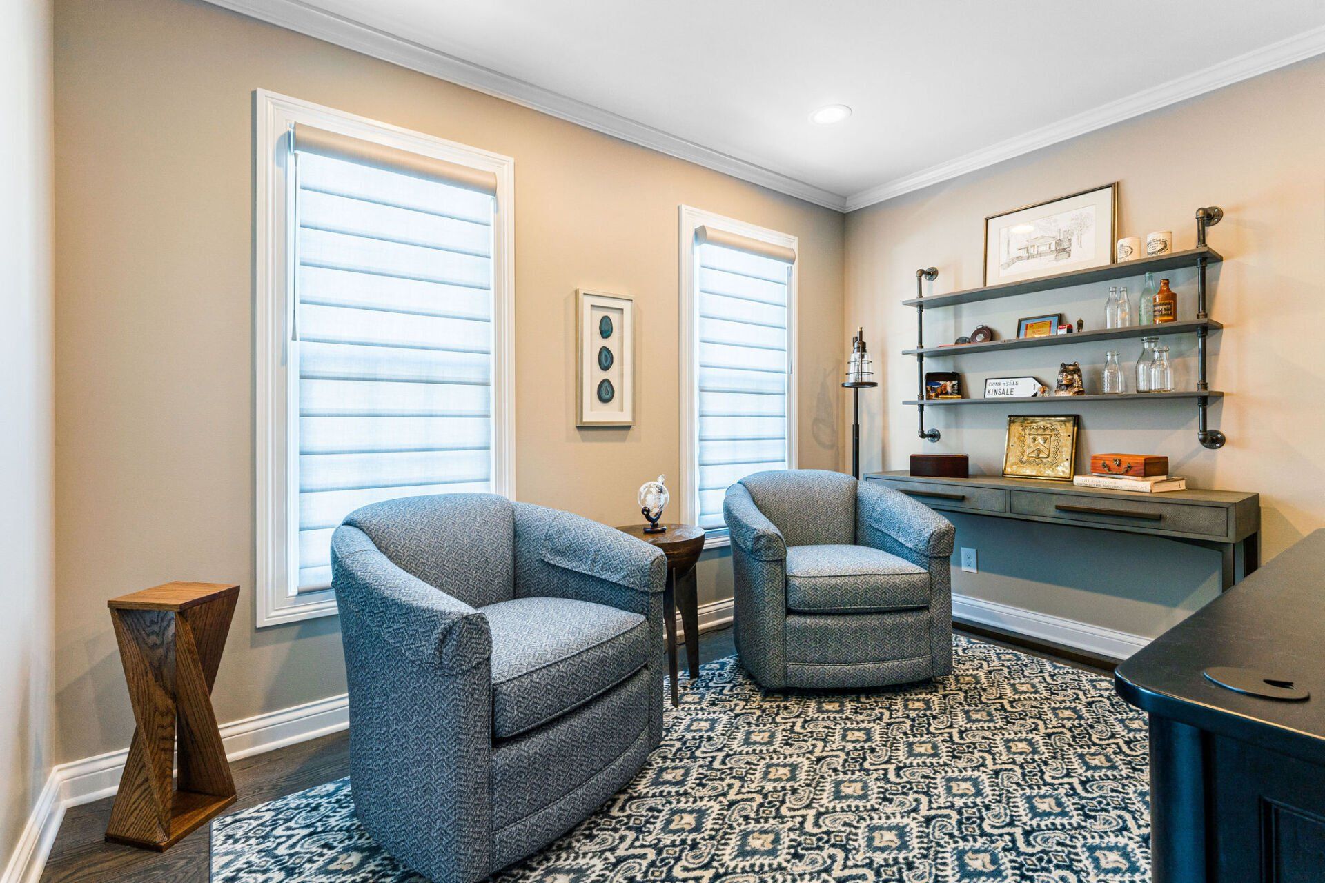 A living room with two chairs and a desk.