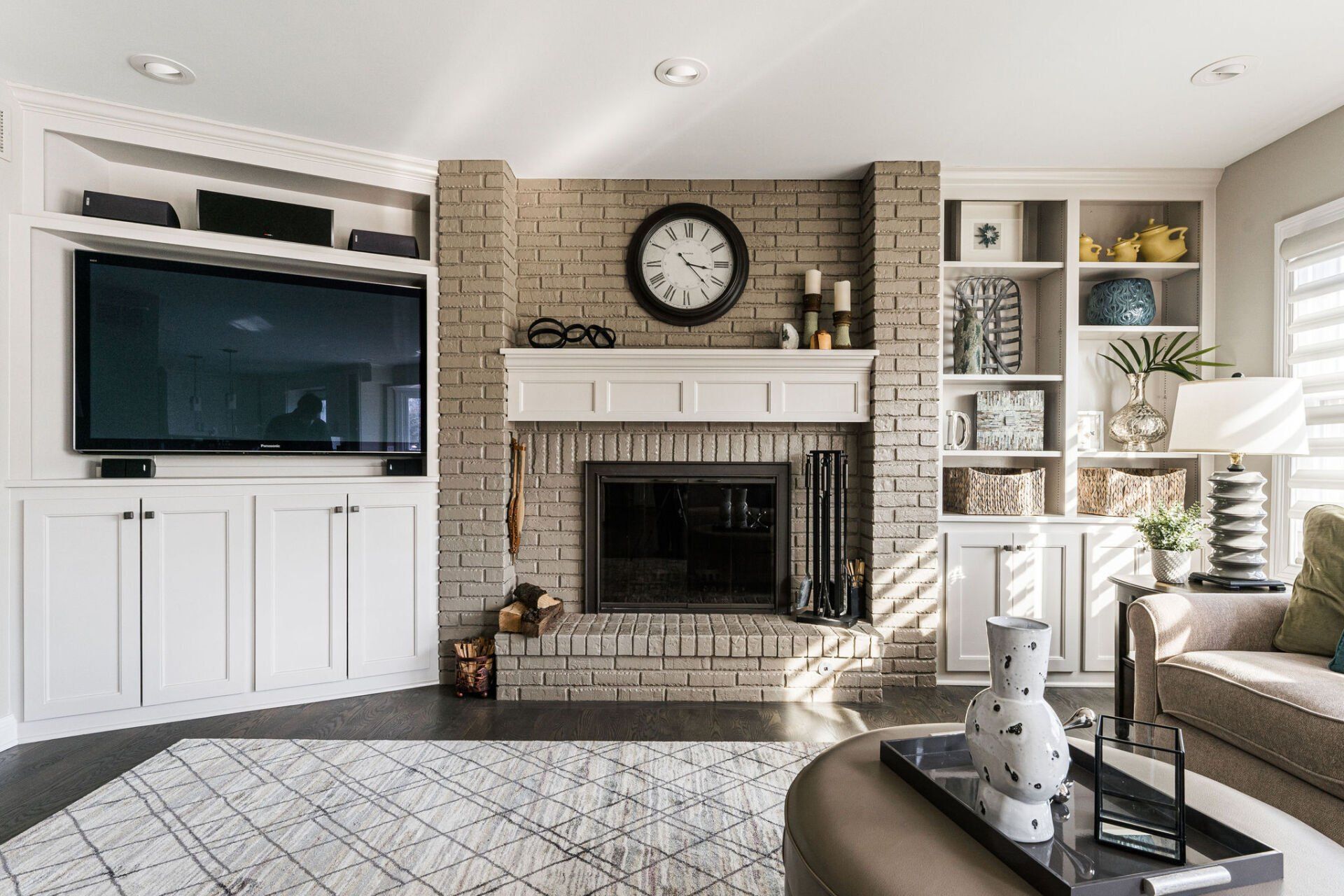 A living room with a fireplace and a flat screen tv.