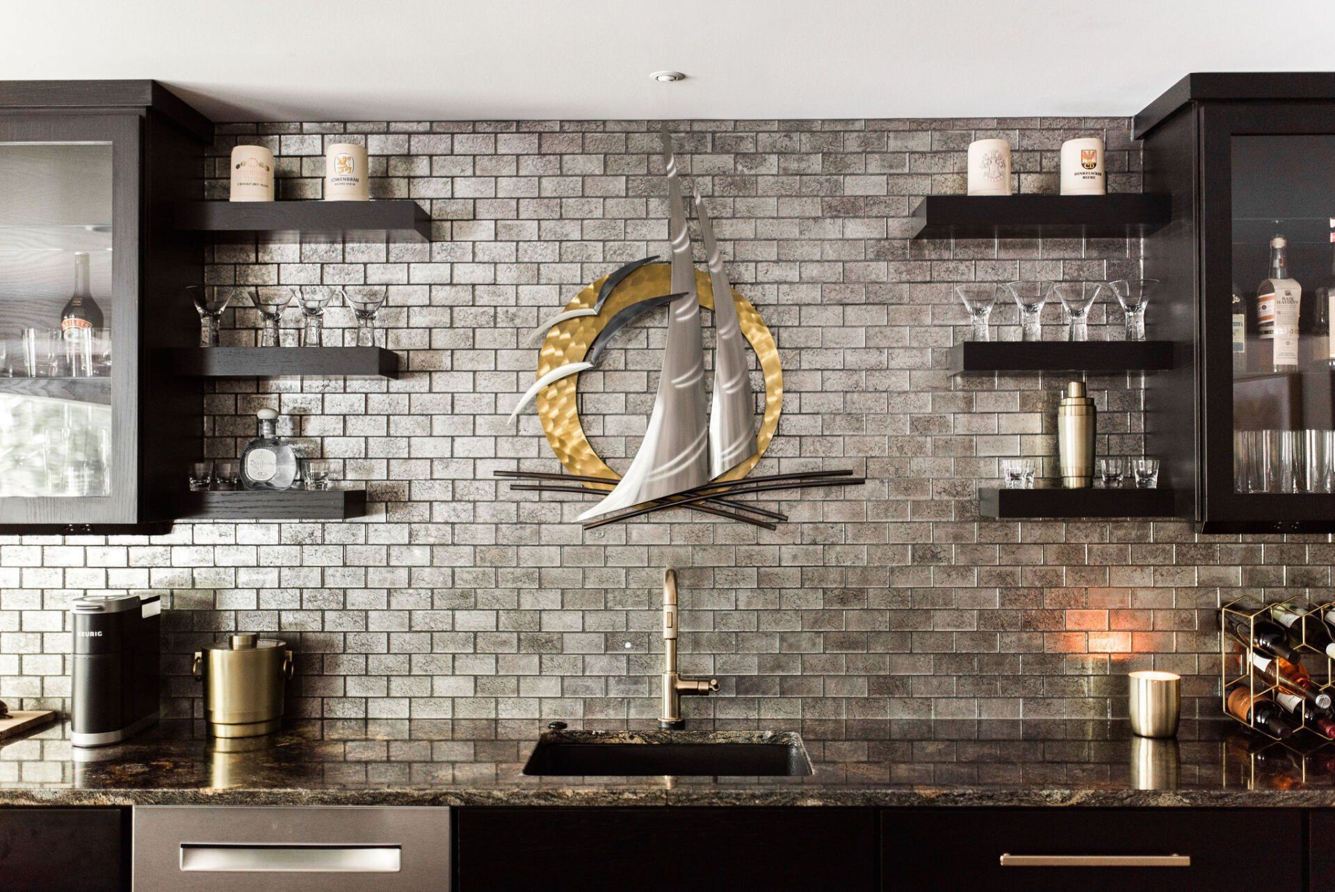 A kitchen with a brick wall and a sink.