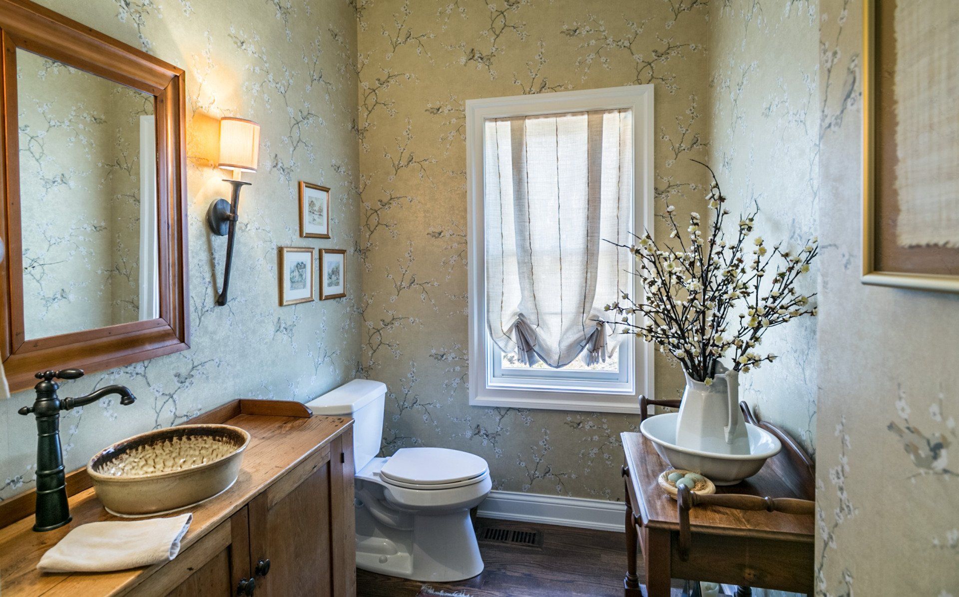 A bathroom with a toilet , sink and mirror