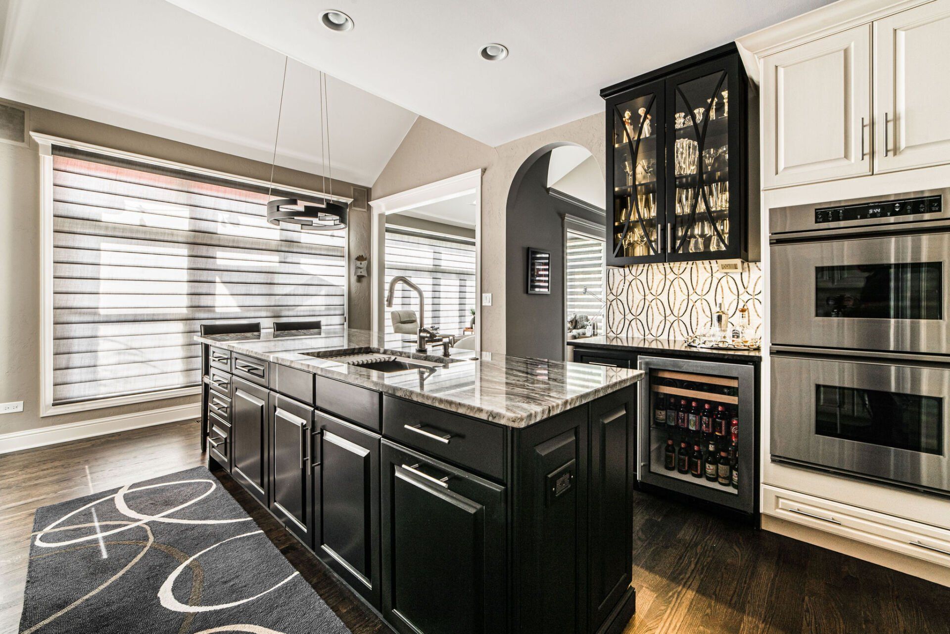 A kitchen with a large island and stainless steel appliances.