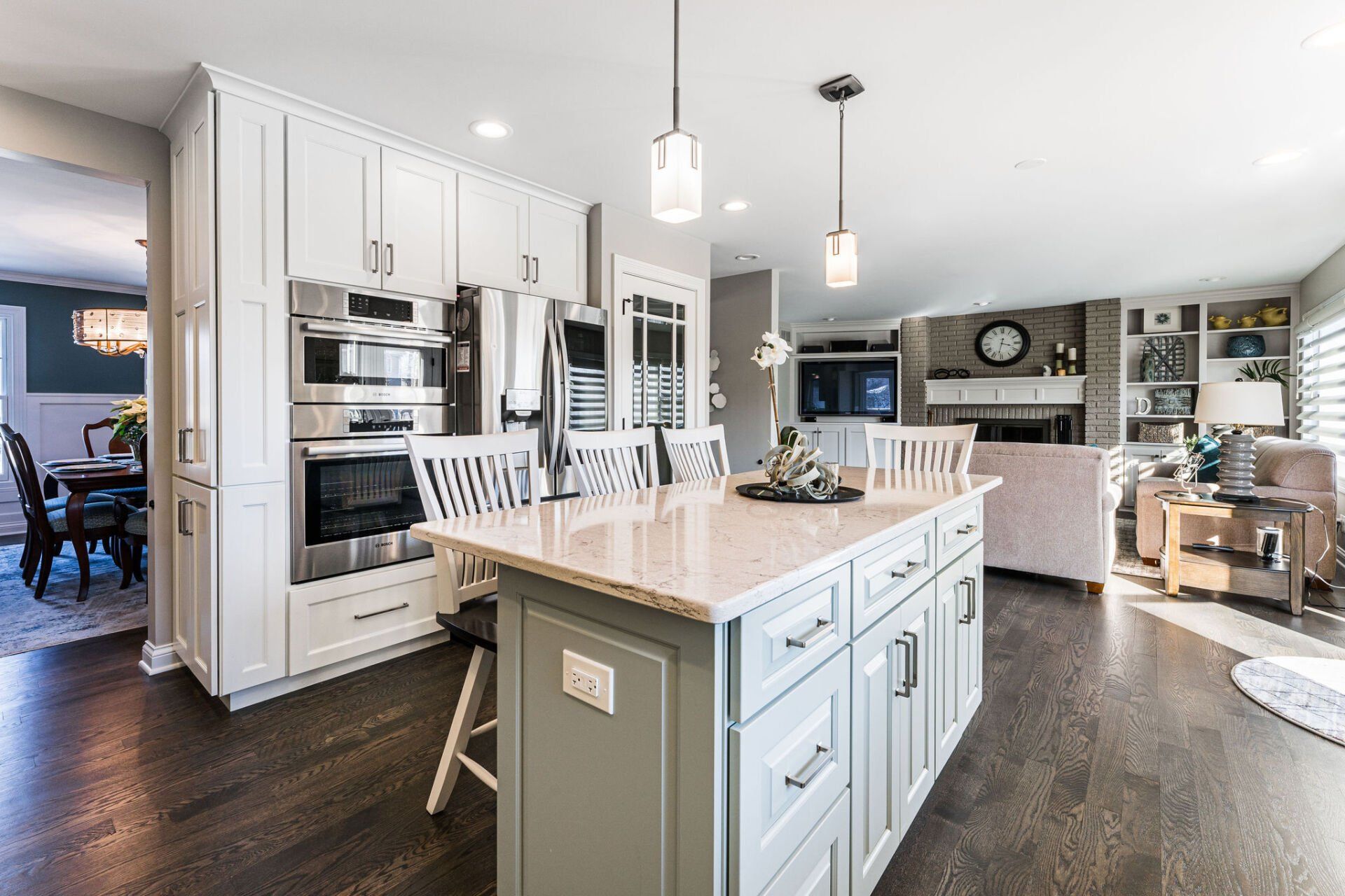 A kitchen with white cabinets and a large island in the middle.