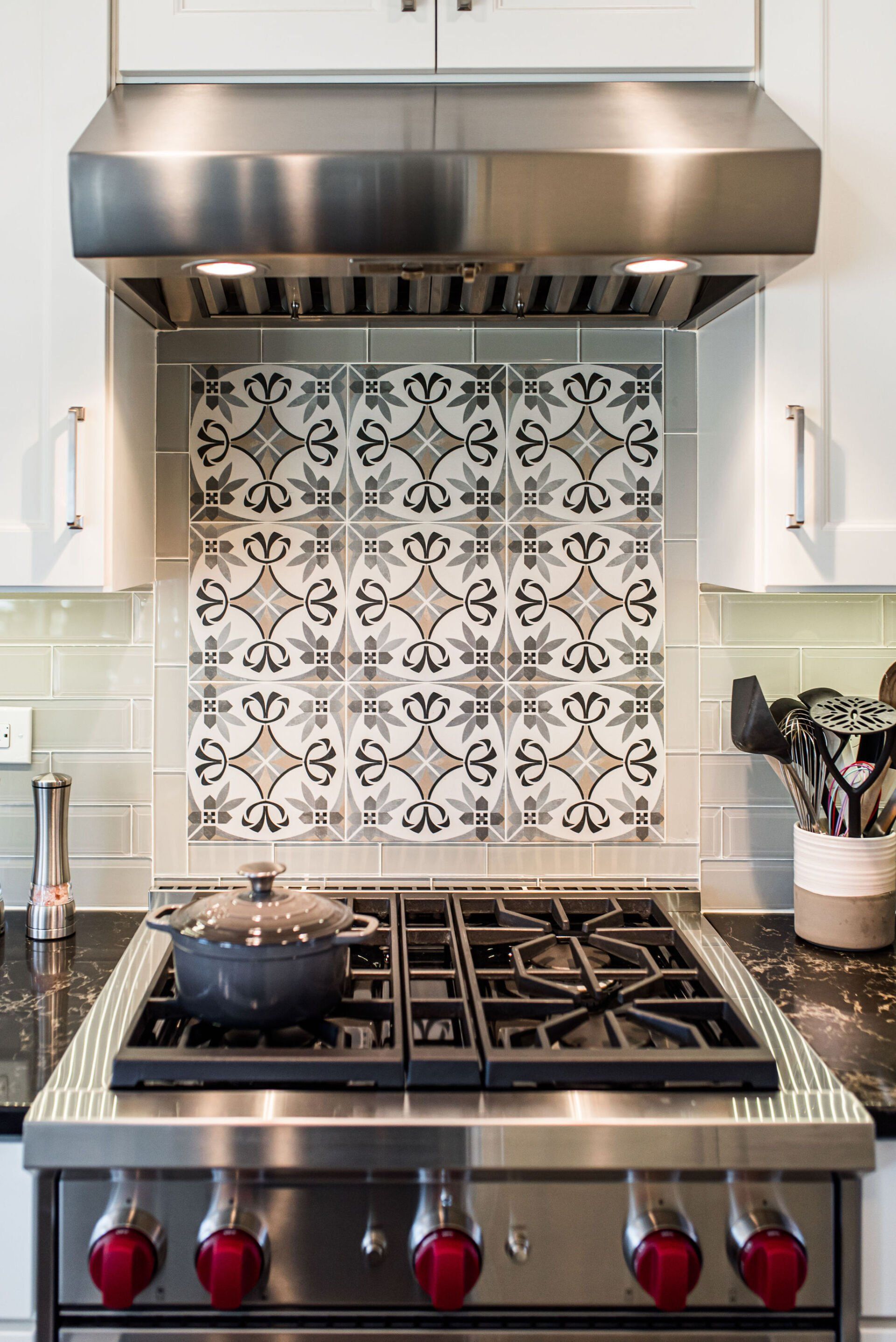 A stove top oven with a pot on it in a kitchen.