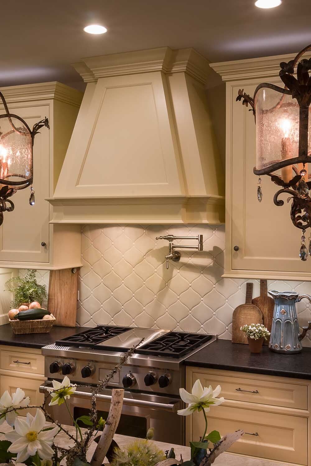 A kitchen with stainless steel appliances and white cabinets