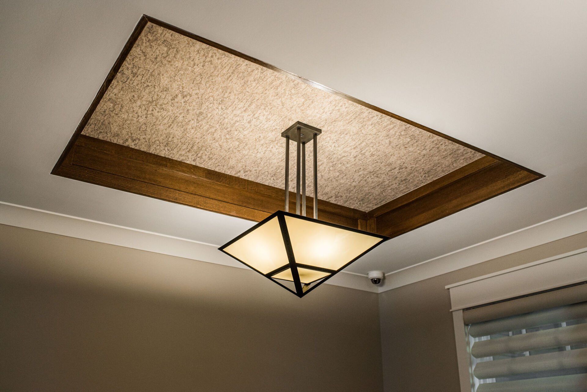 A ceiling light is hanging from the ceiling of a room.