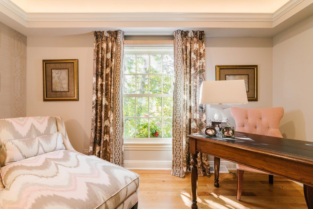 A home office with a desk , chair and chaise lounge.