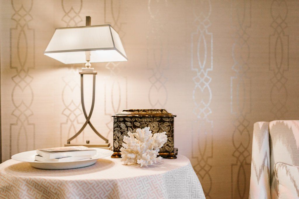 A table with a lamp and a box on it