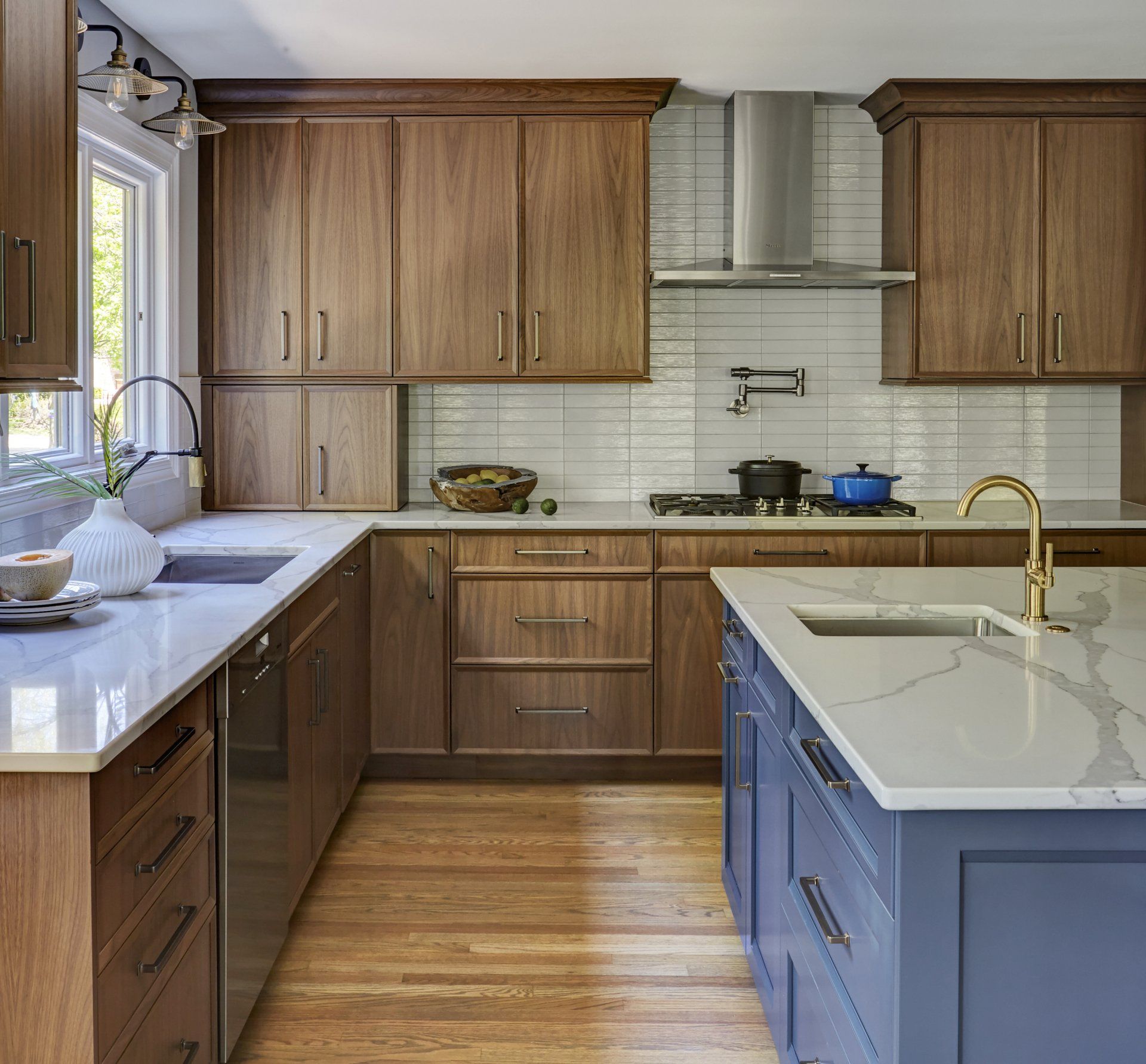 A kitchen with wooden cabinets and a blue island.