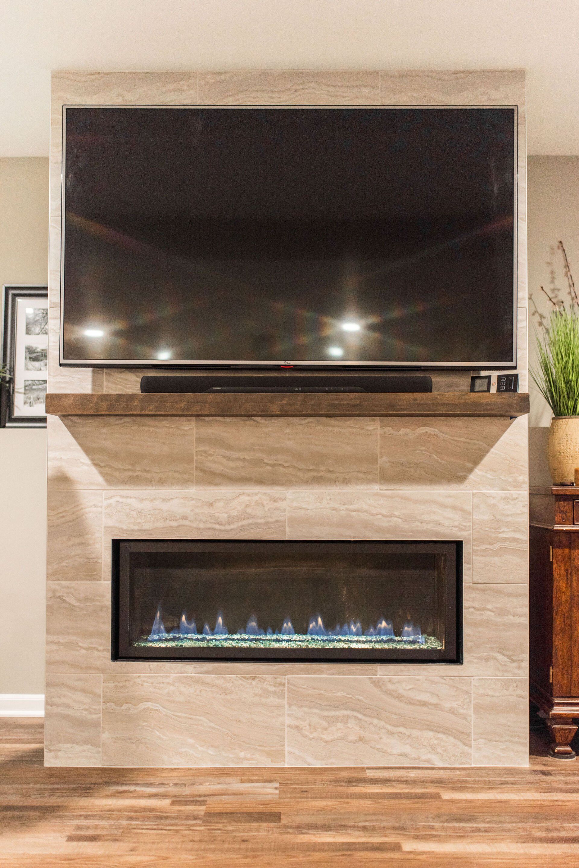 A living room with a fireplace and a flat screen tv.