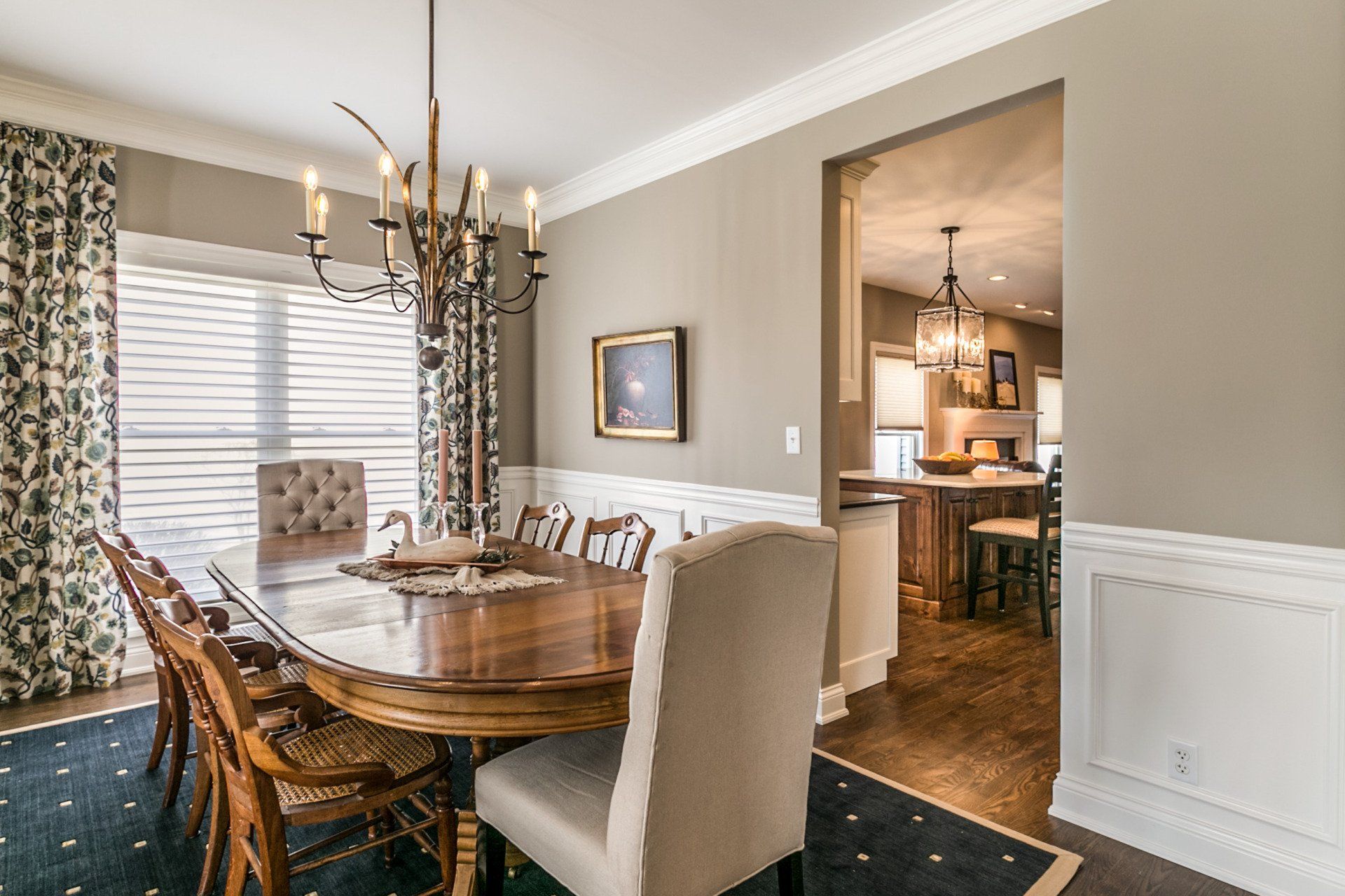 A dining room with a table and chairs and a chandelier.