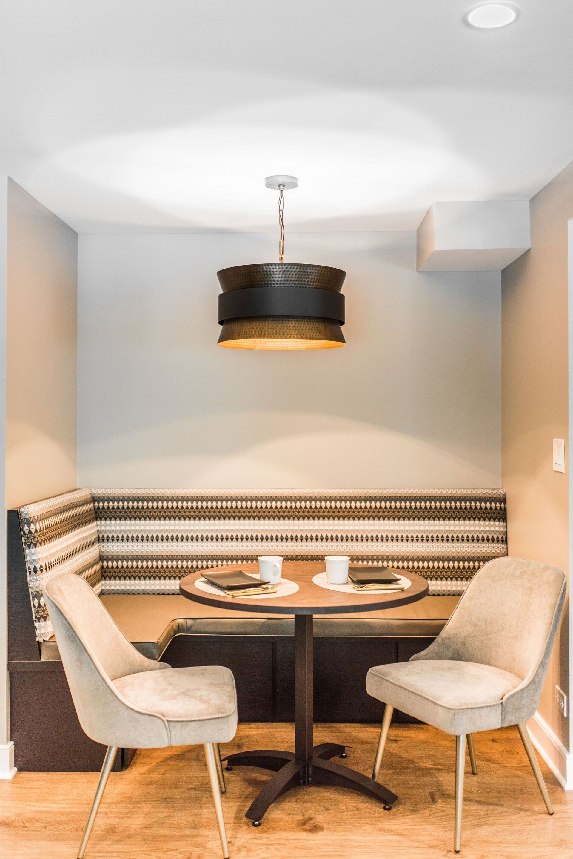 There is a table and chairs in the corner of the room.