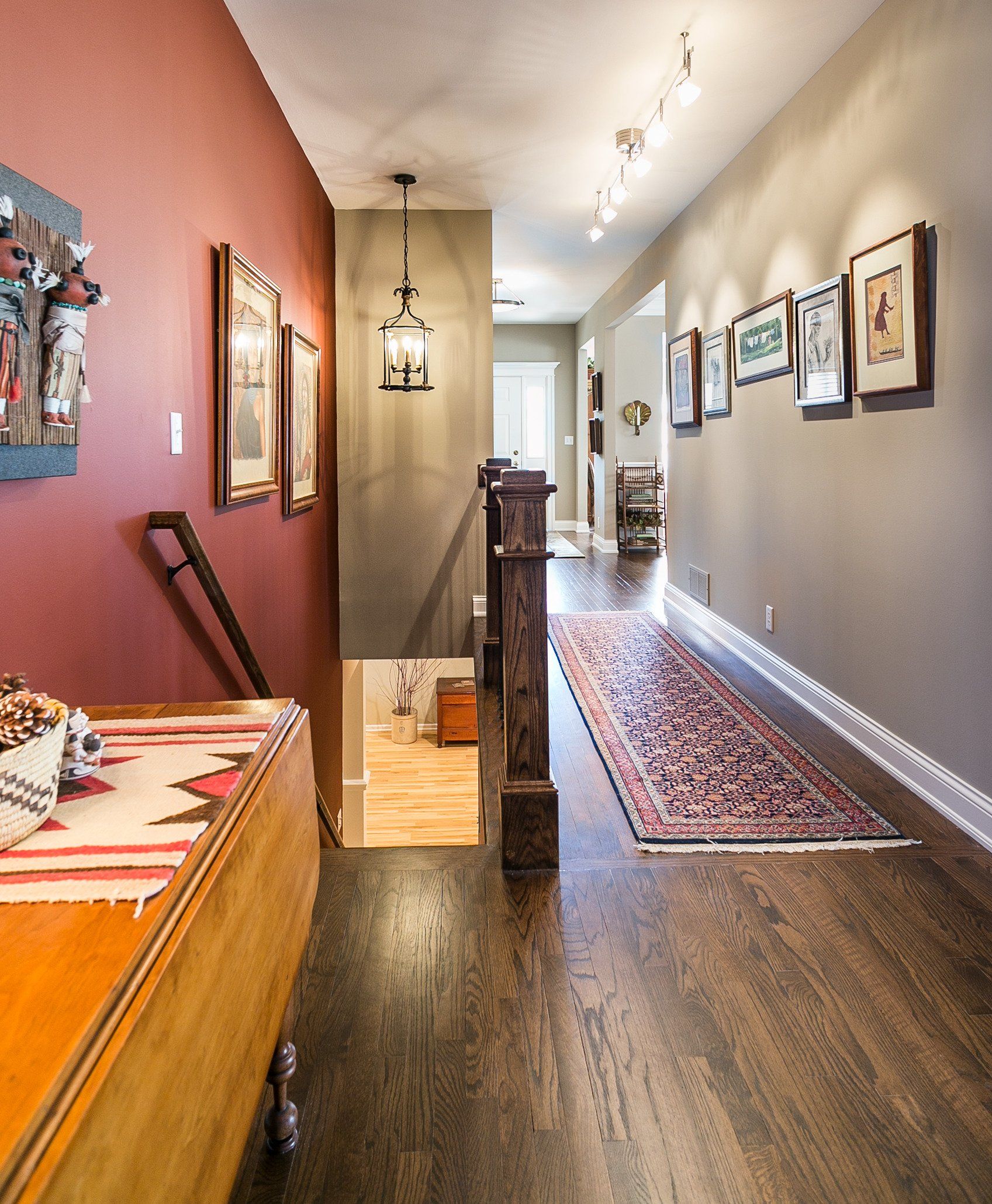 A long hallway with a wooden table in the middle