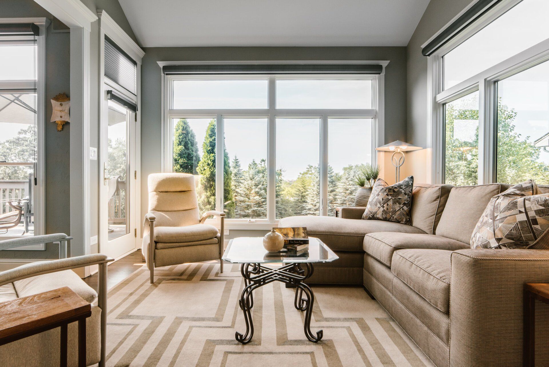 A living room with a couch , chairs , and a coffee table.