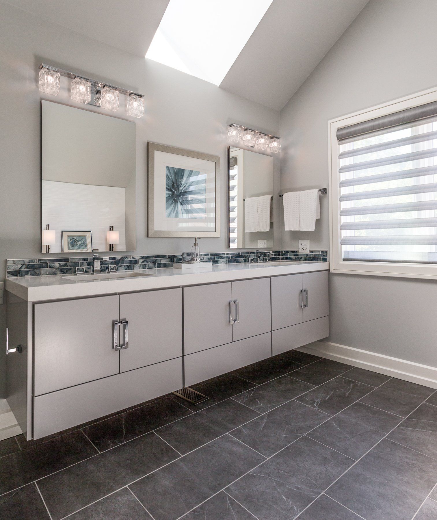 A bathroom with two sinks and a large mirror