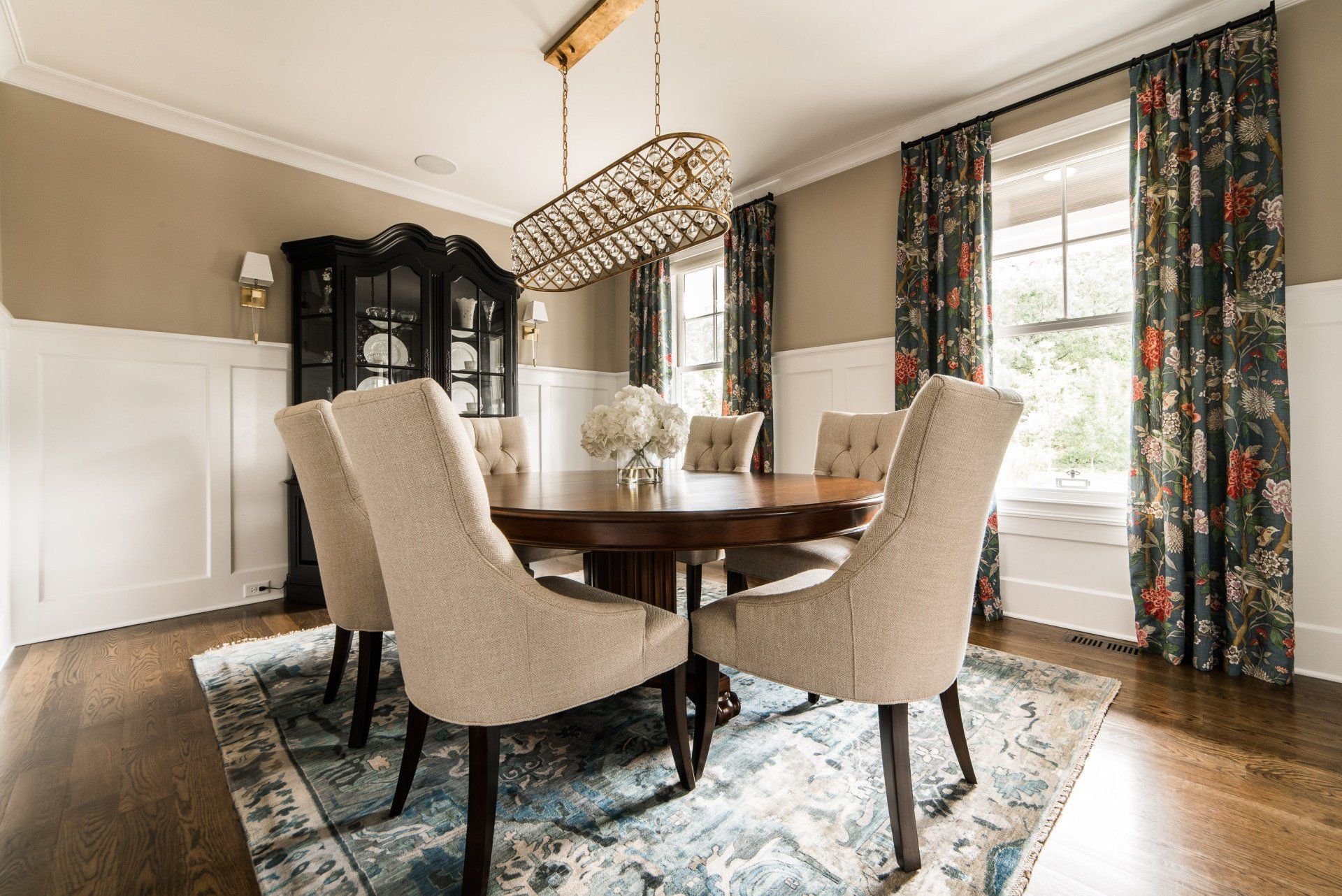 A dining room with a table and chairs and a chandelier.