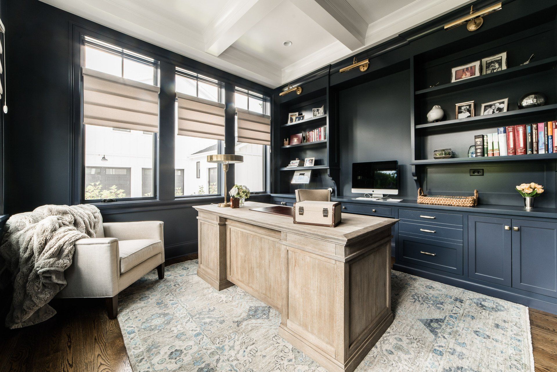 A home office with a desk , chair , and bookshelves.
