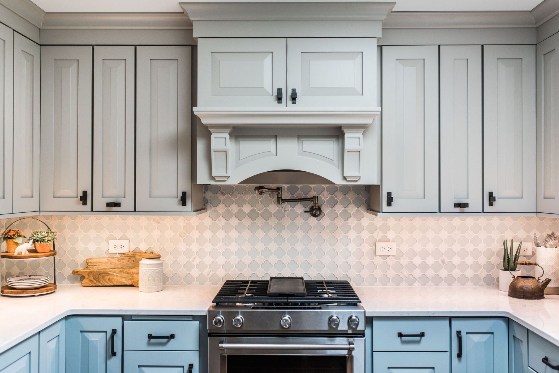 A kitchen with blue cabinets and a stove top oven.