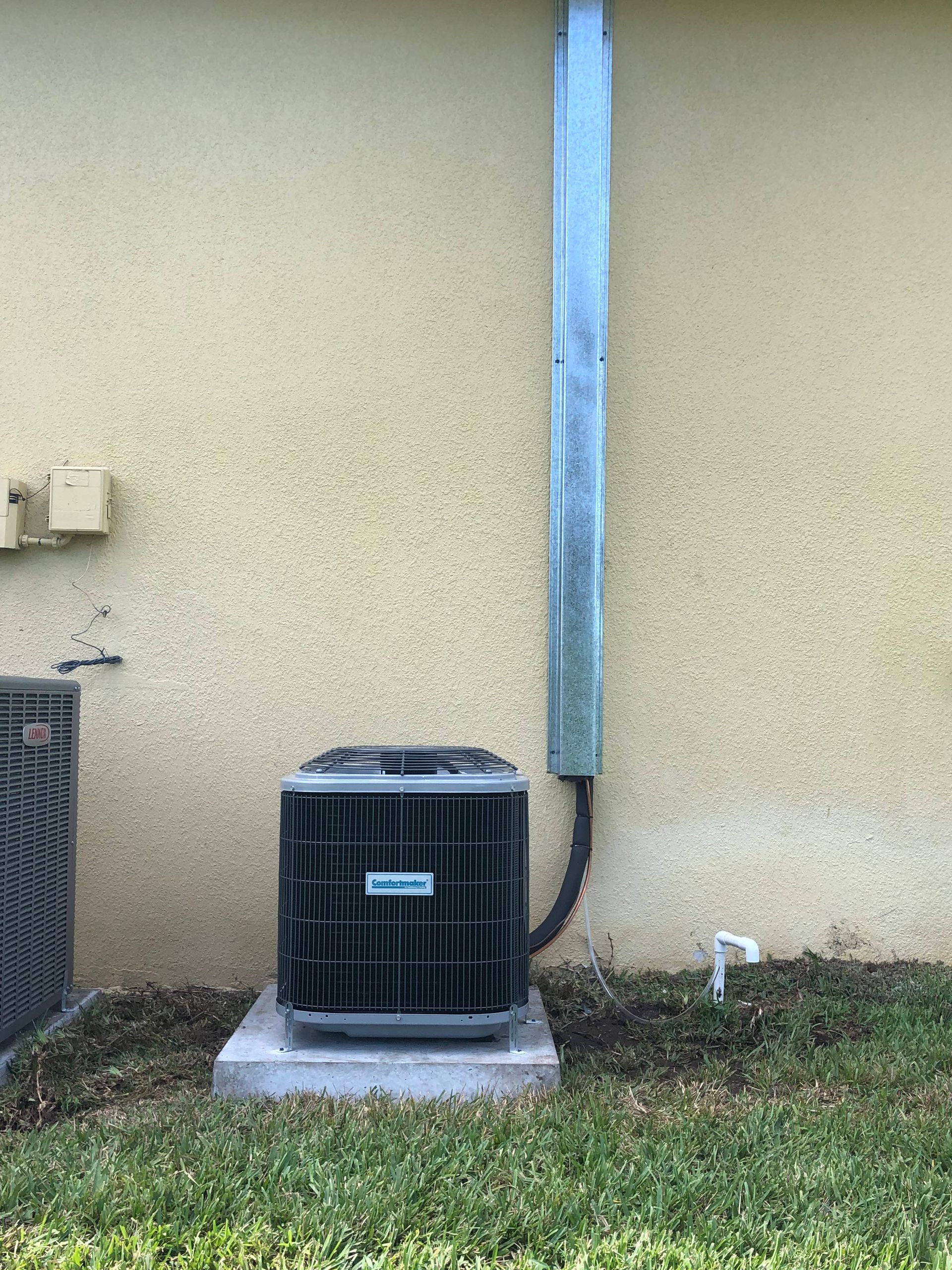 an air conditioner is sitting on the side of a building .