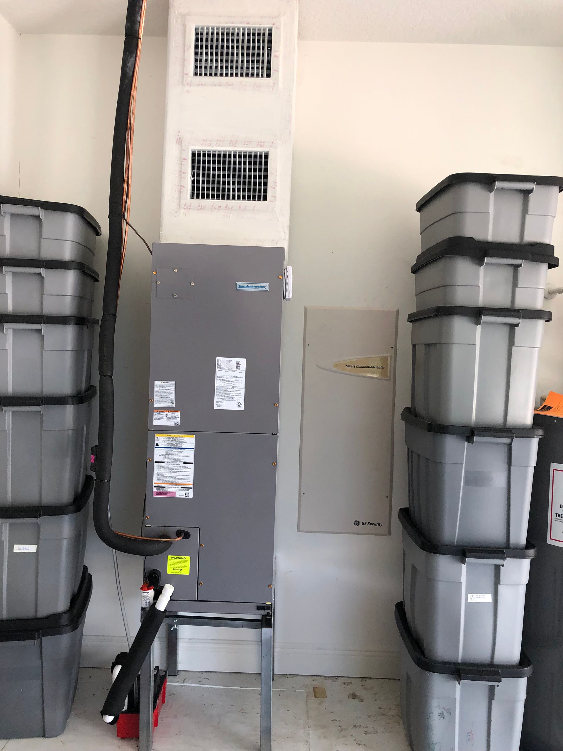 a room with a stack of boxes and a heater