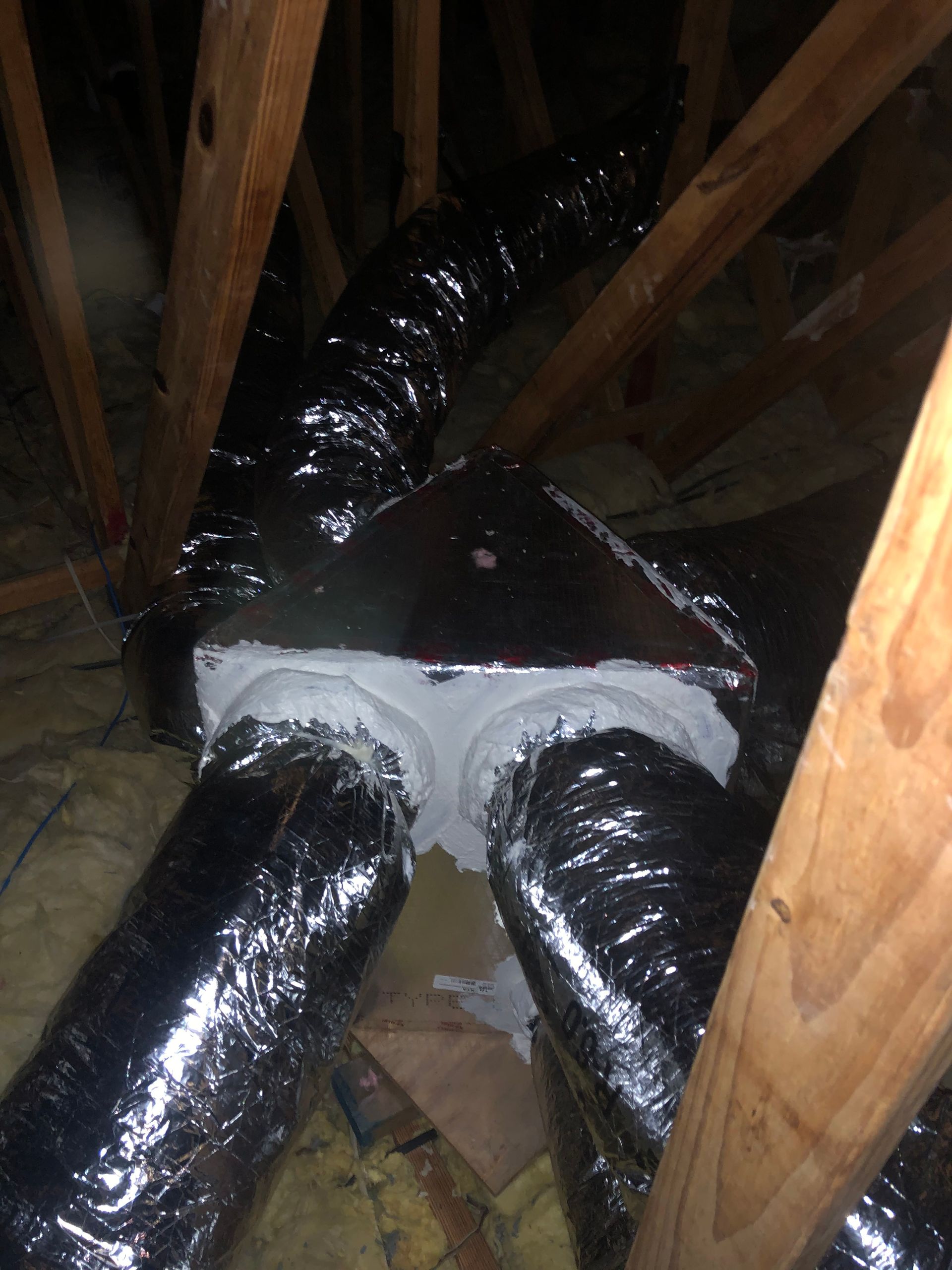 a bunch of ducts are hanging from the ceiling of a building .