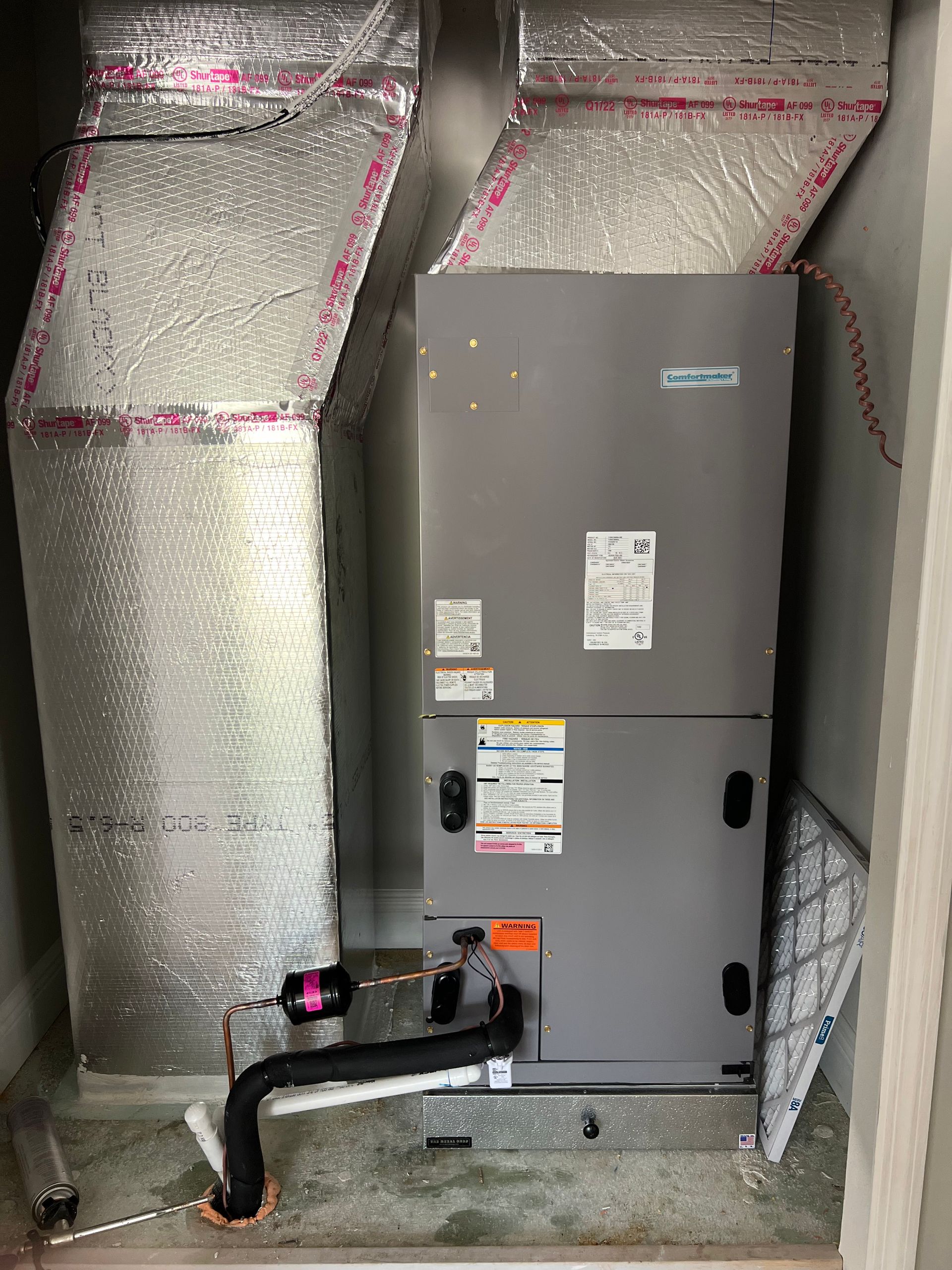 a room with a heater and ducts coming out of it .