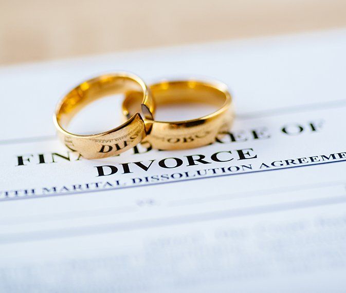 Divorce Paper And A Set Of Gold Wedding Rings — Law Firm in Taree, NSW