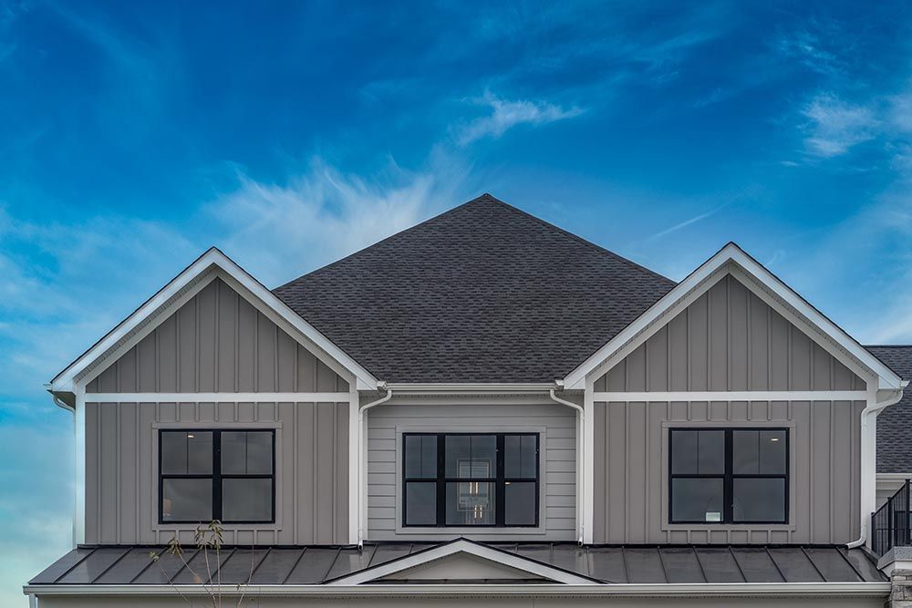 The roof of a house with a blue sky in the background.