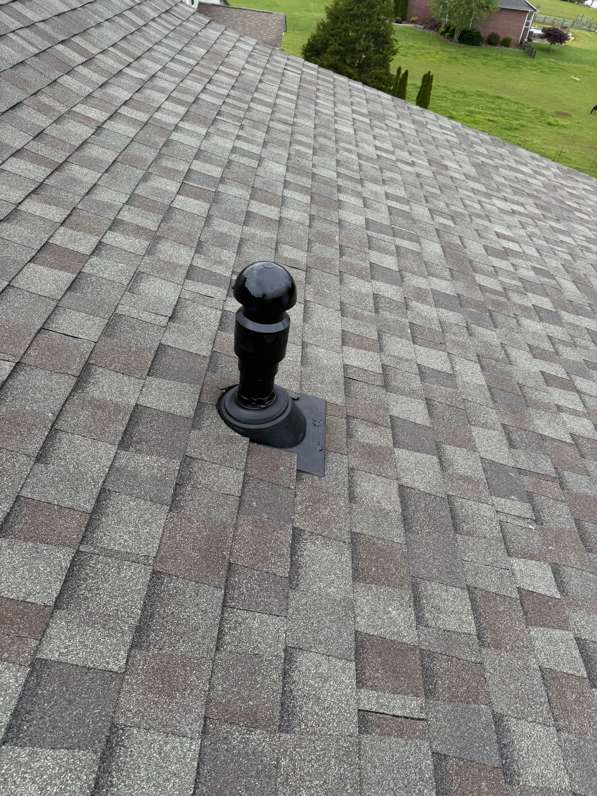 A close up of a roof with a chimney on it.