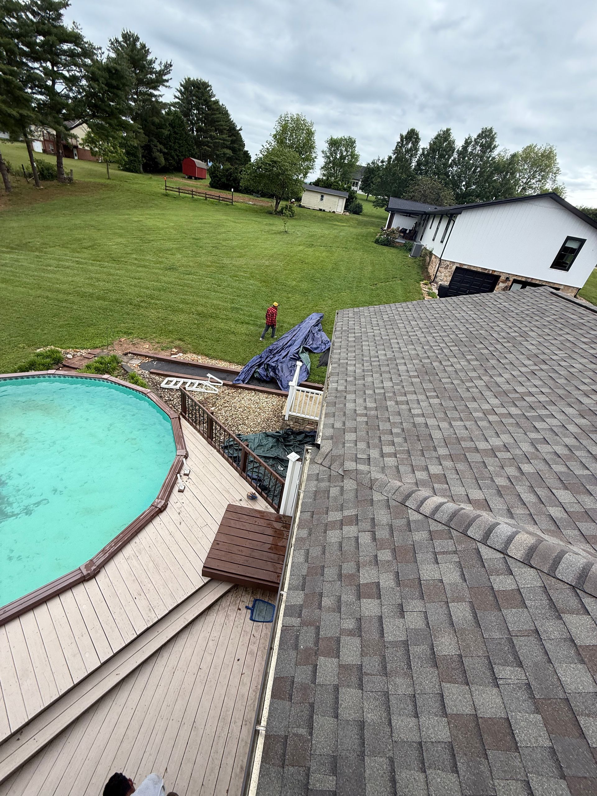 An aerial view of a house with a pool in the backyard.