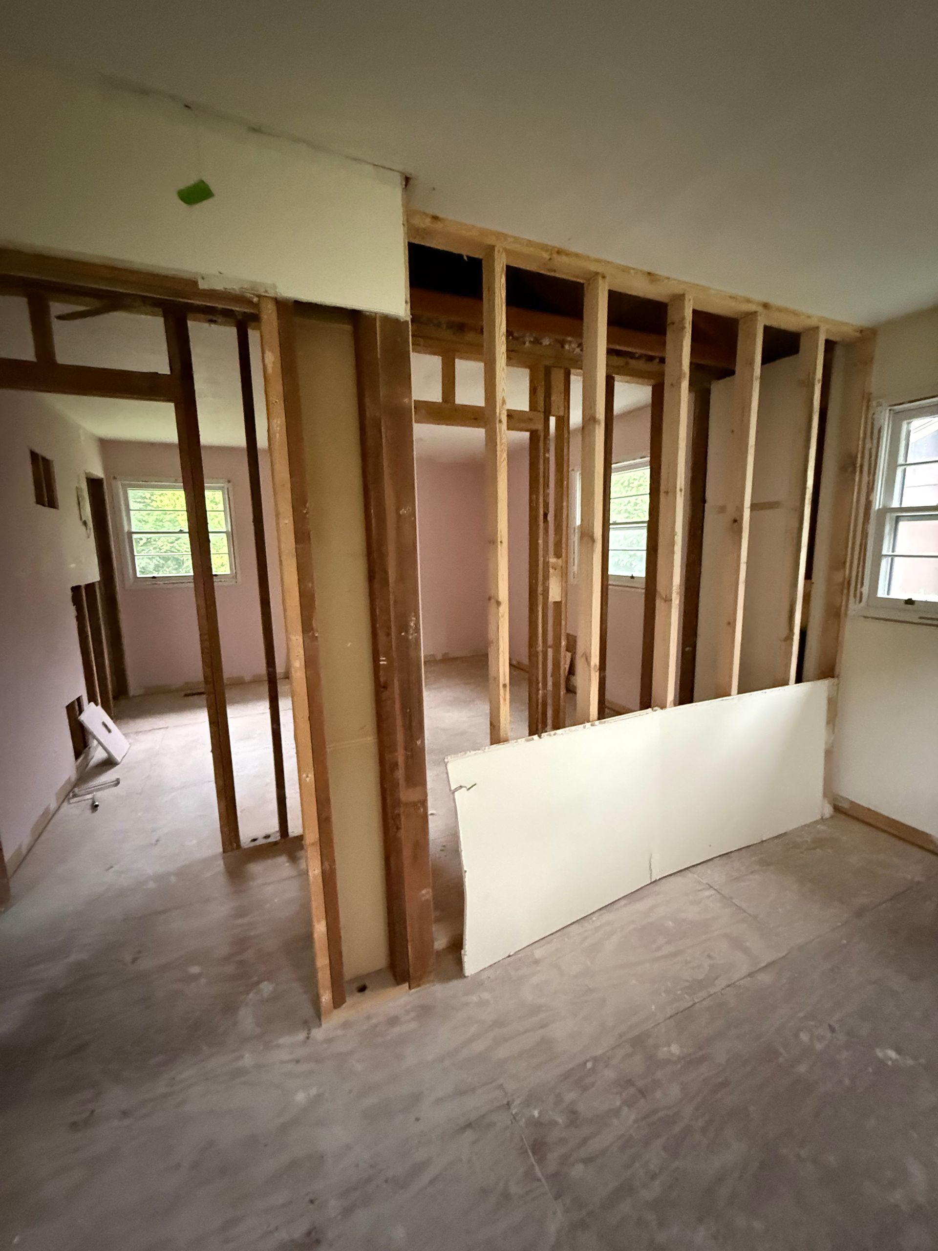 A room that is being remodeled with wooden walls and a window.