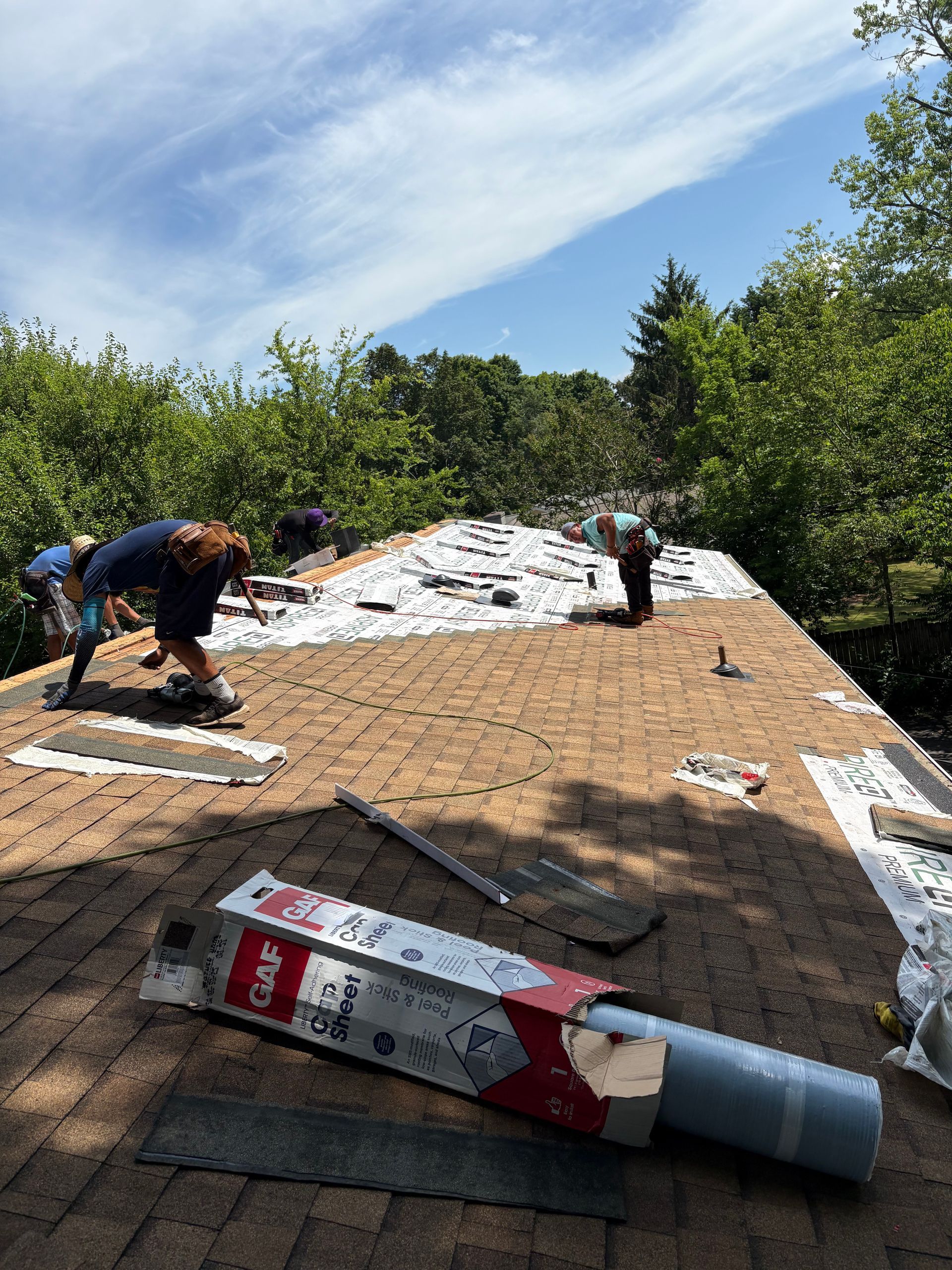 A group of people are working on a roof.