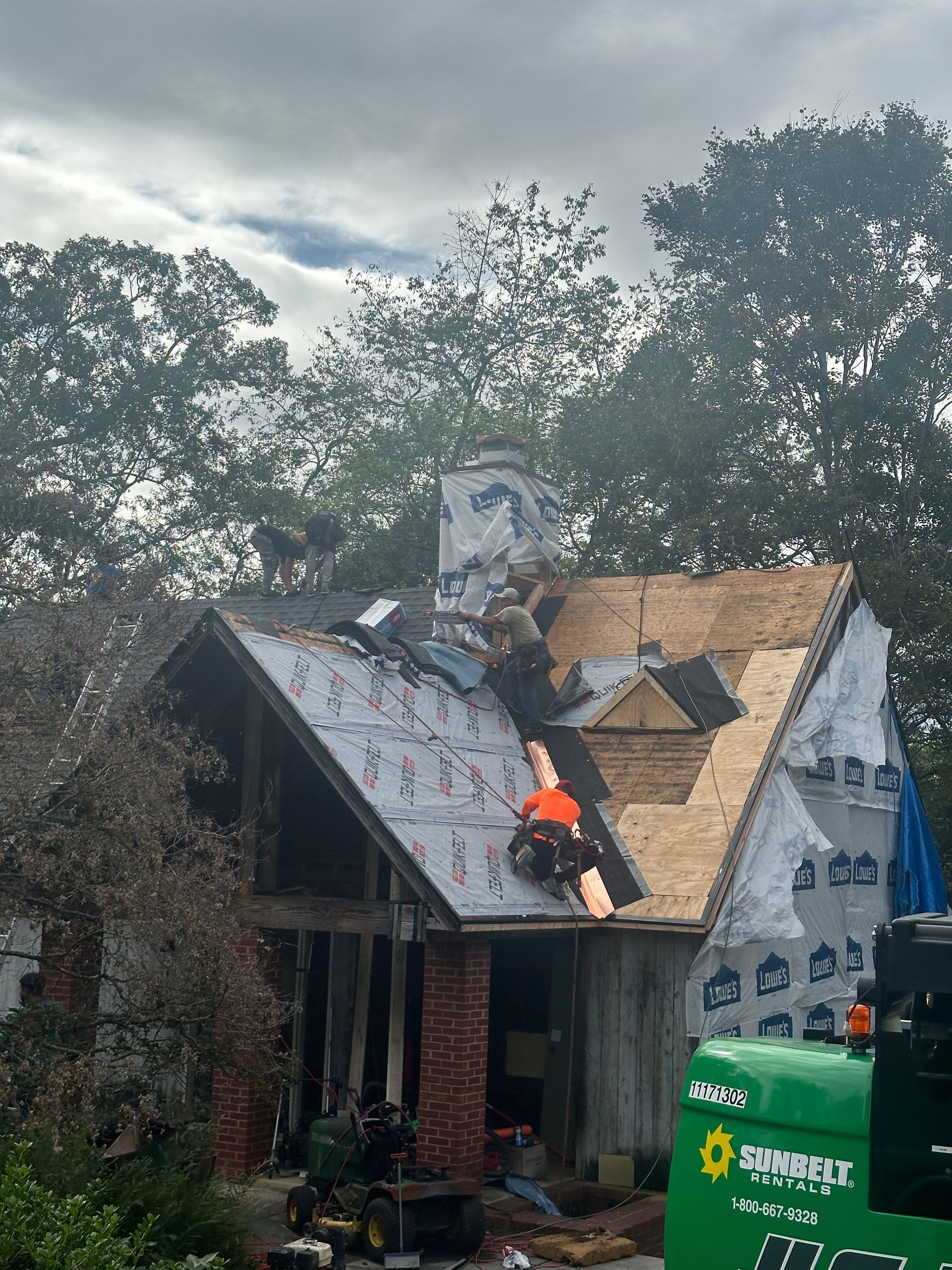 A man is working on the roof of a house.
