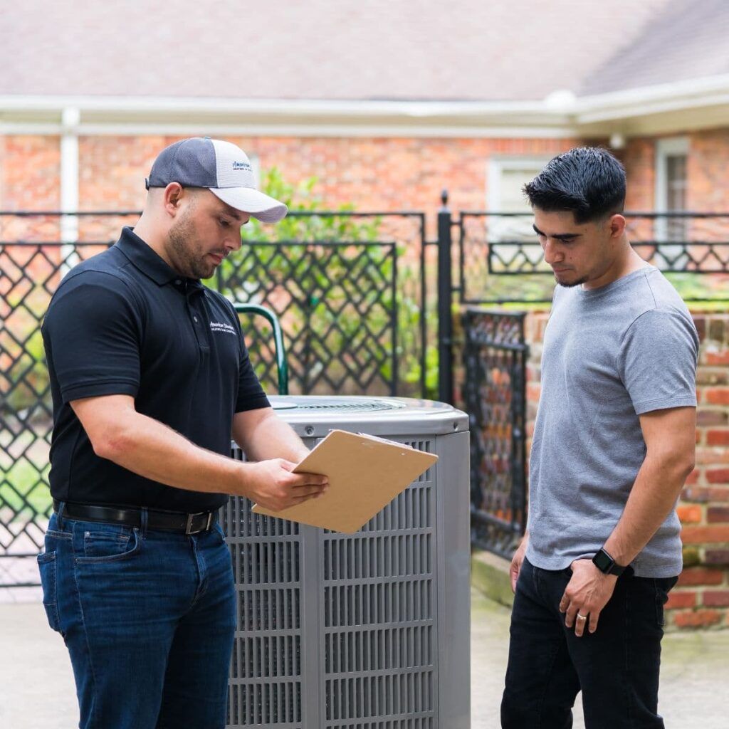 Premier HVAC technician educating Provo homeowner about AC maintenance