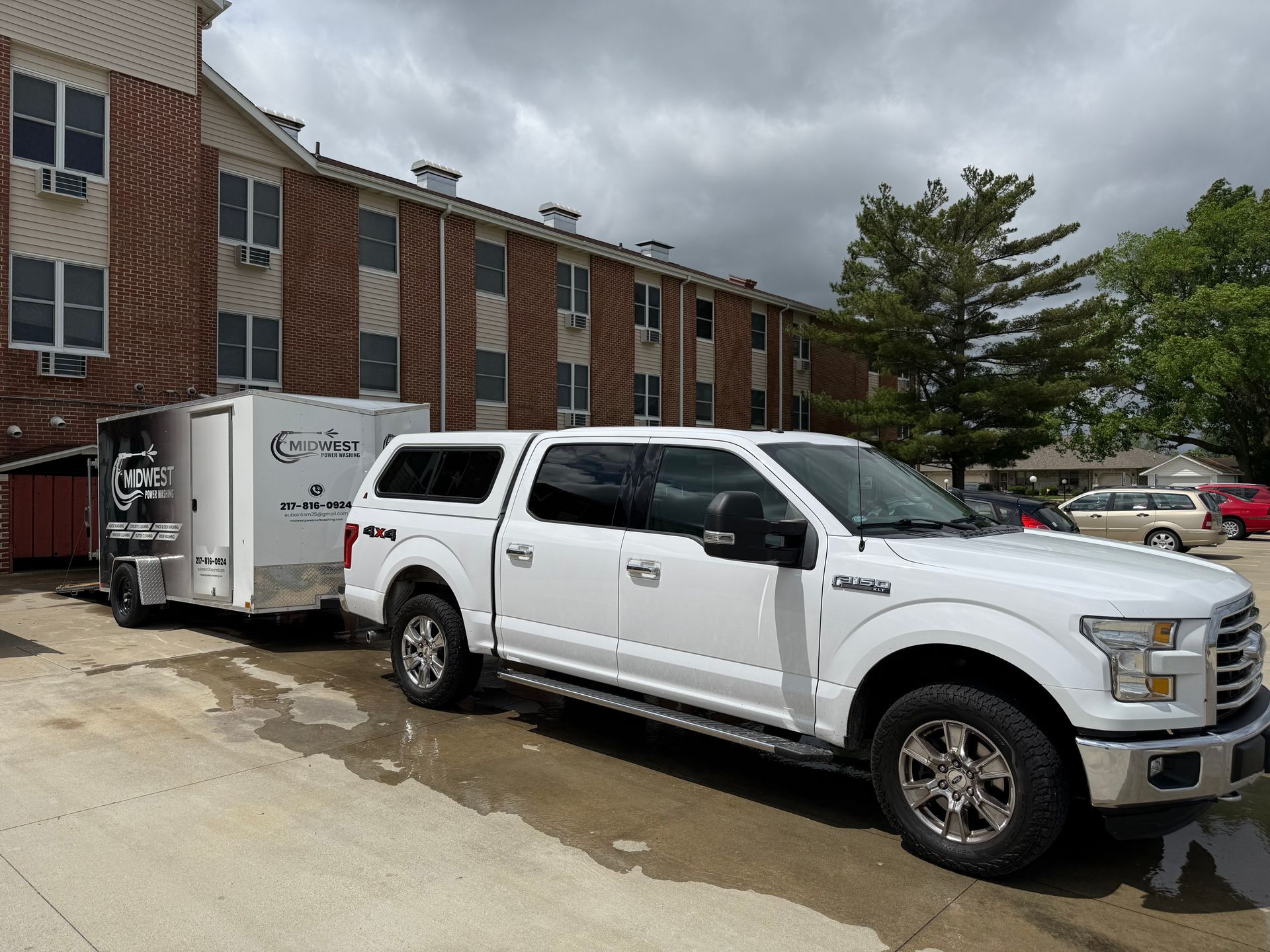 White Pickup Truck Pulling a Trailer in Front of a Brick Building — Springfield, IL — Midwest Power/Soft Washing