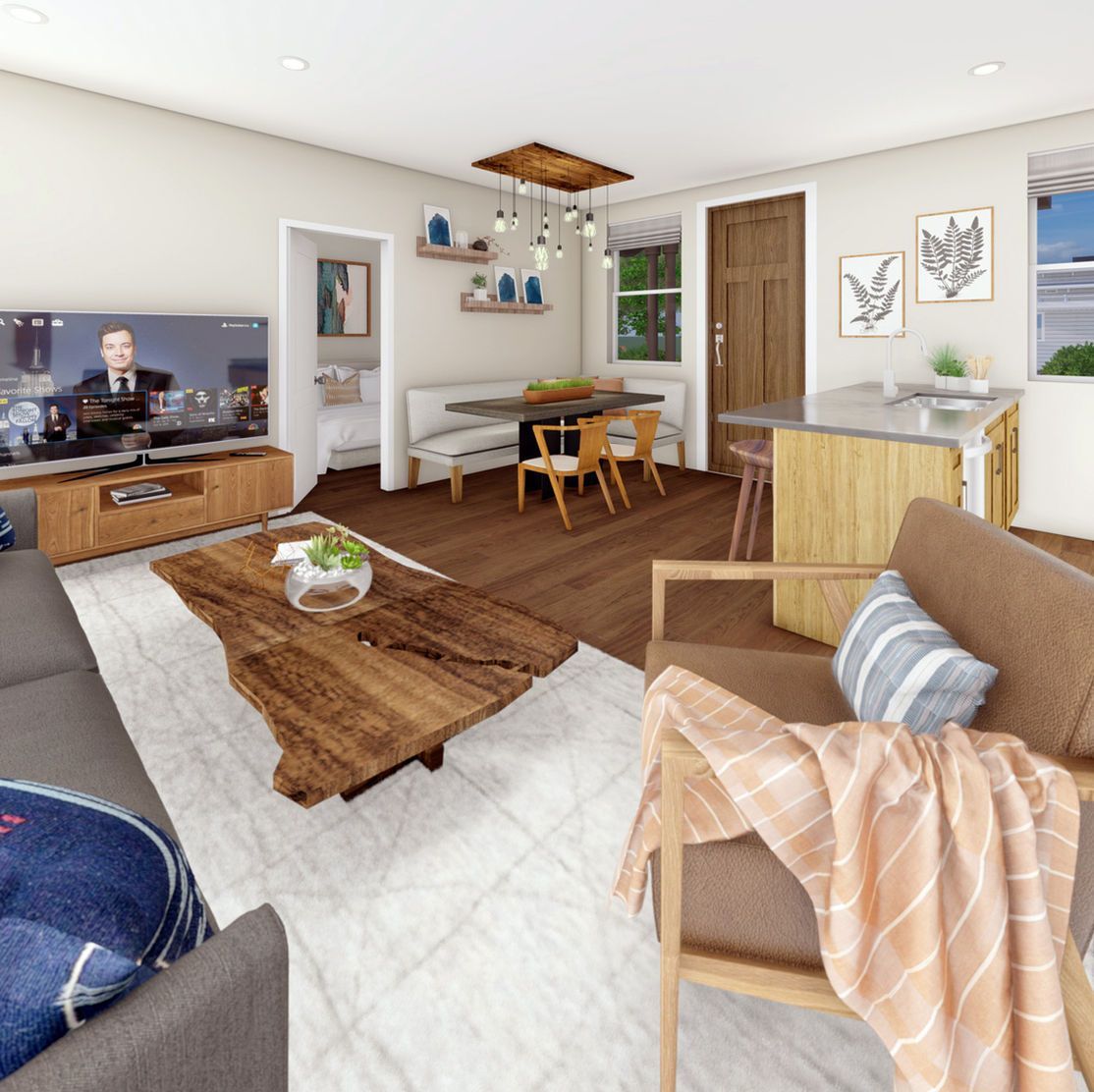 Cozy living room with TV, rustic coffee table, dining area, and armchair.