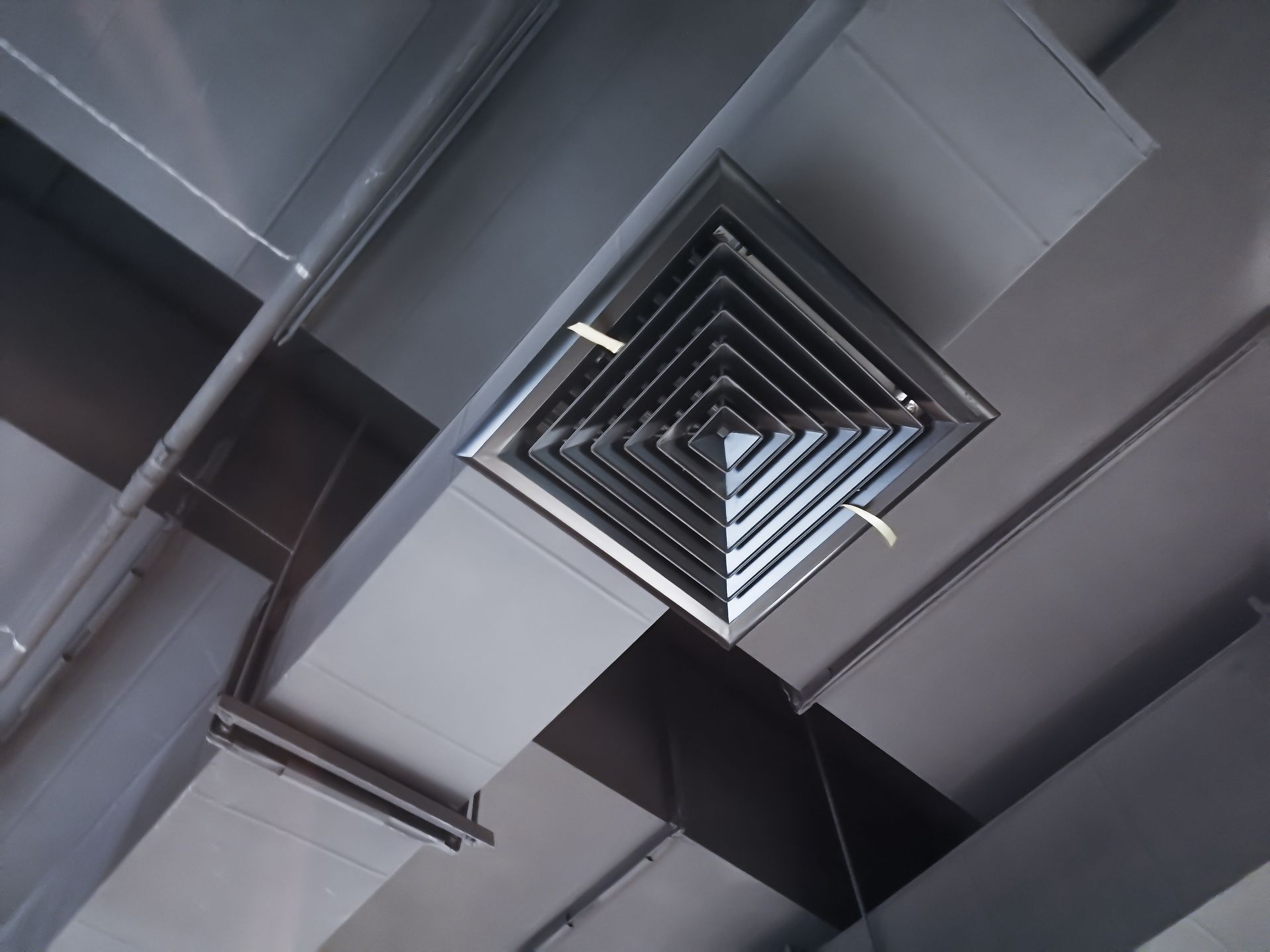 Ceiling vent and silver ductwork in an industrial interior