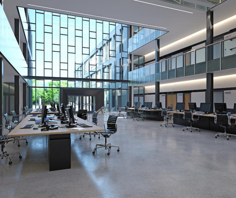 Modern open-plan office with desks, computers, glass walls, and a large skylit atrium Modern open-plan office with desks, computers, glass walls, and a large skylit atrium