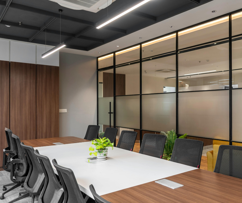 Modern conference room with a white table, black chairs, wood accents, and glass partition walls Modern conference room with a white table, black chairs, wood accents, and glass partition walls