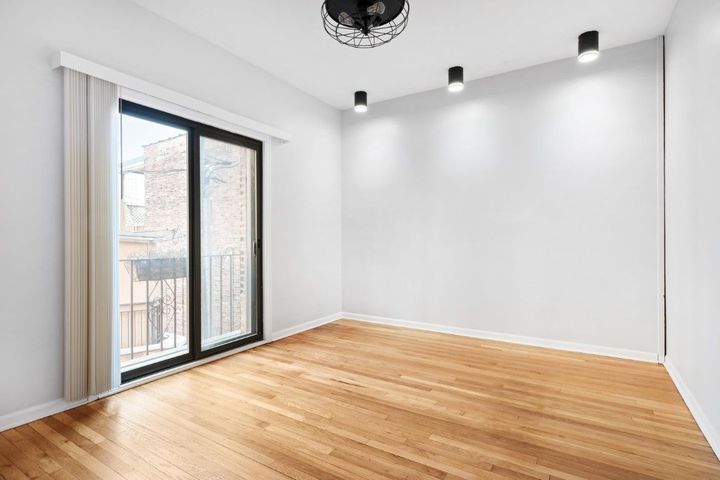 Clear empty room with a window and light bulbs shining on the wall.