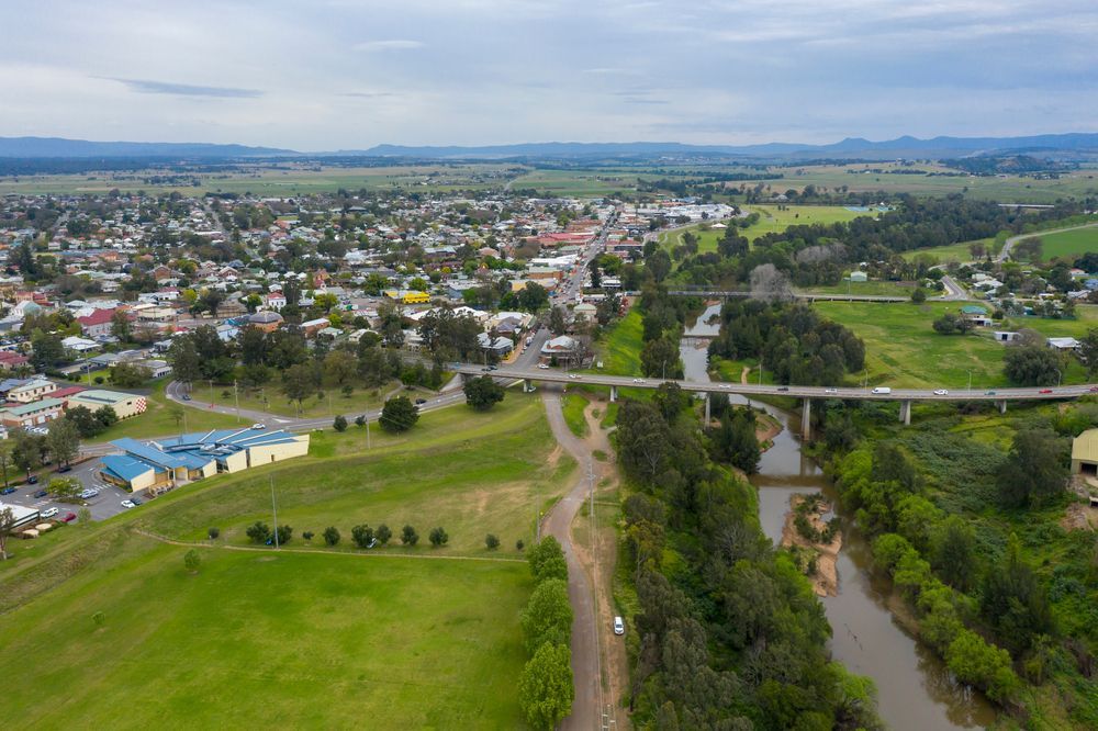 Aerial View of a Town Beside a Winding River and Bridge — Concrete Colour Solutions in Singleton, NSW