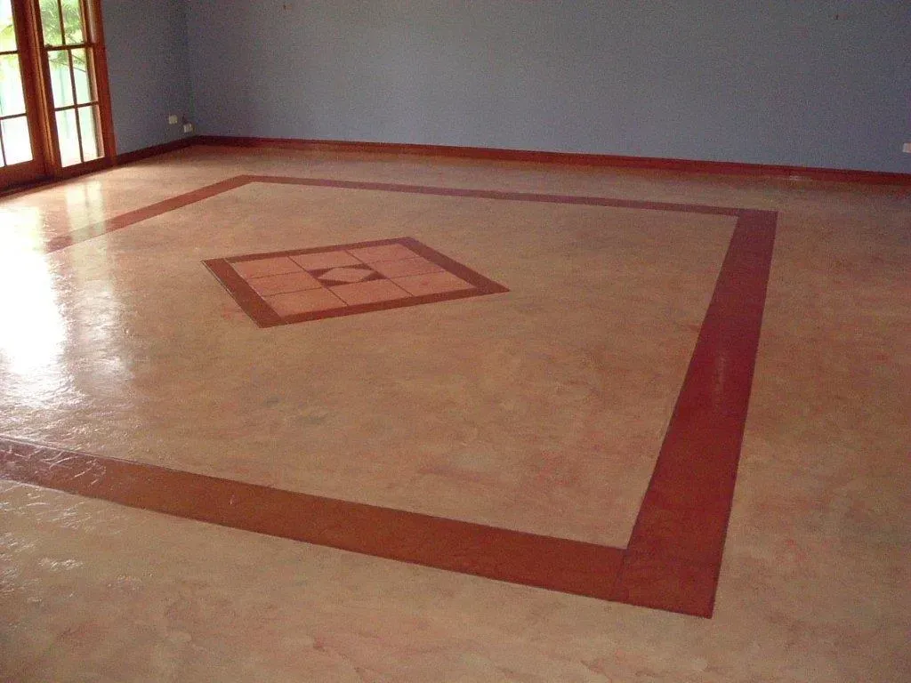 An empty room with a square design on the floor — Concrete Colour Solutions in Morisset, NSW
