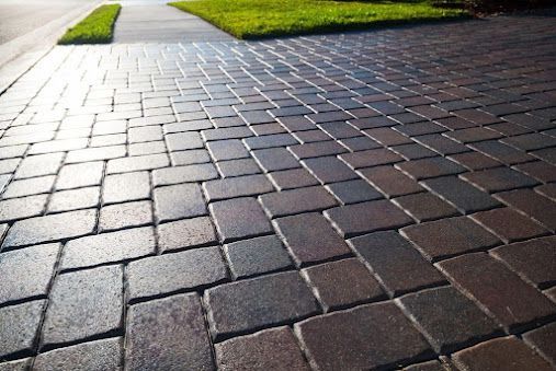 A Brick Driveway with A Sidewalk in The Background — Concrete Colour Solutions in Morisset, NSW
