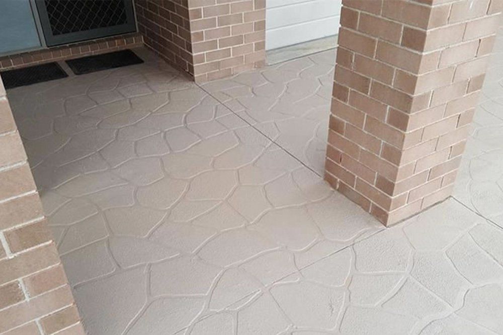 A Patio Outside A Luxury Looking House — Concrete Colour Solutions in Morisset, NSW