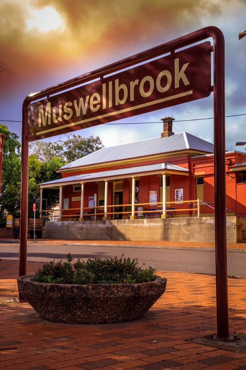 Haweswellbrook Sign in Front of a Red-brick Building at Sunset — Concrete Colour Solutions in Muswellbrook, NSW