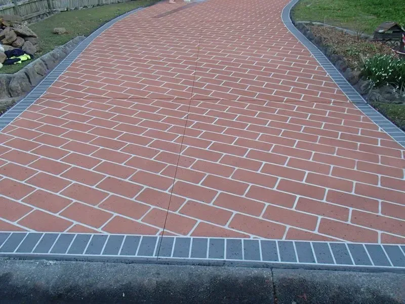 A red brick walkway with a gray border — Concrete Colour Solutions in Morisset, NSW