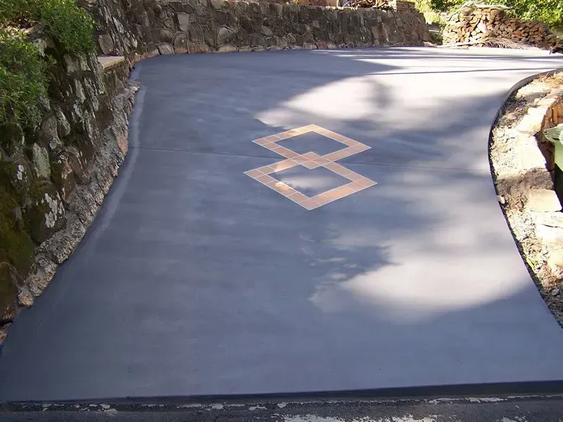 A concrete driveway with a diamond design on it — Concrete Colour Solutions in Morisset, NSW