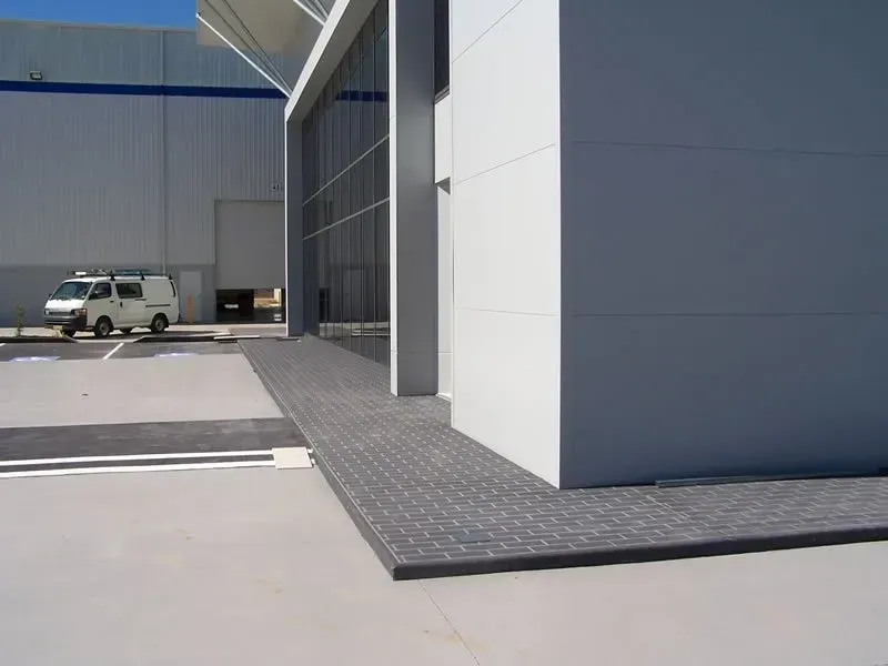 A white van is parked in front of a building — Concrete Colour Solutions in Morisset, NSW