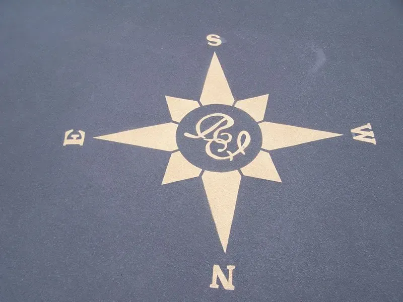 A compass with the letter r on it — Concrete Colour Solutions in Morisset, NSW