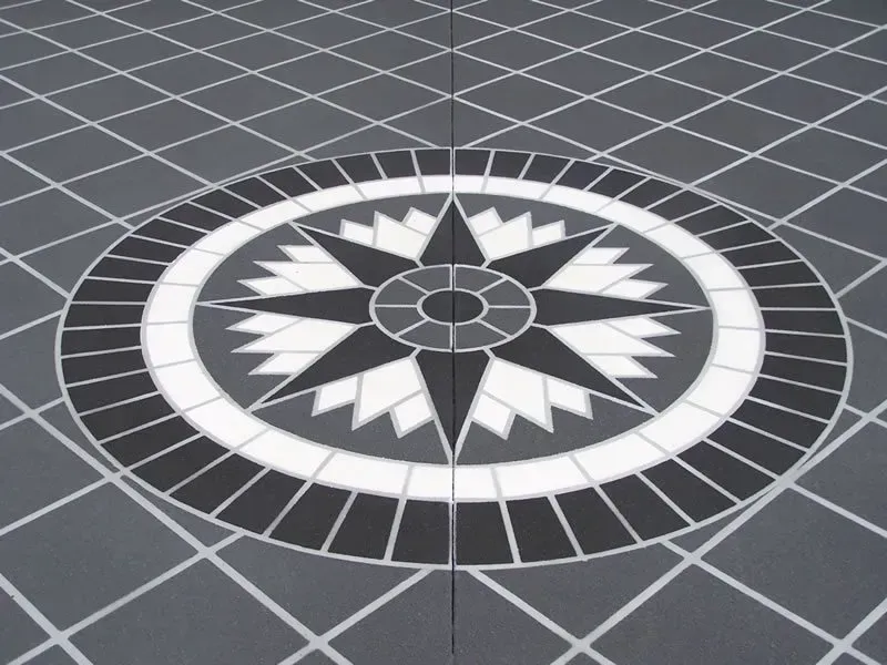 A black and white circle with a star in the center — Concrete Colour Solutions in Morisset, NSW