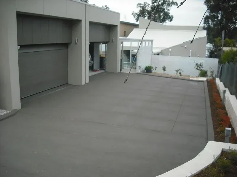 A concrete driveway in front of a house — Concrete Colour Solutions in Morisset, NSW